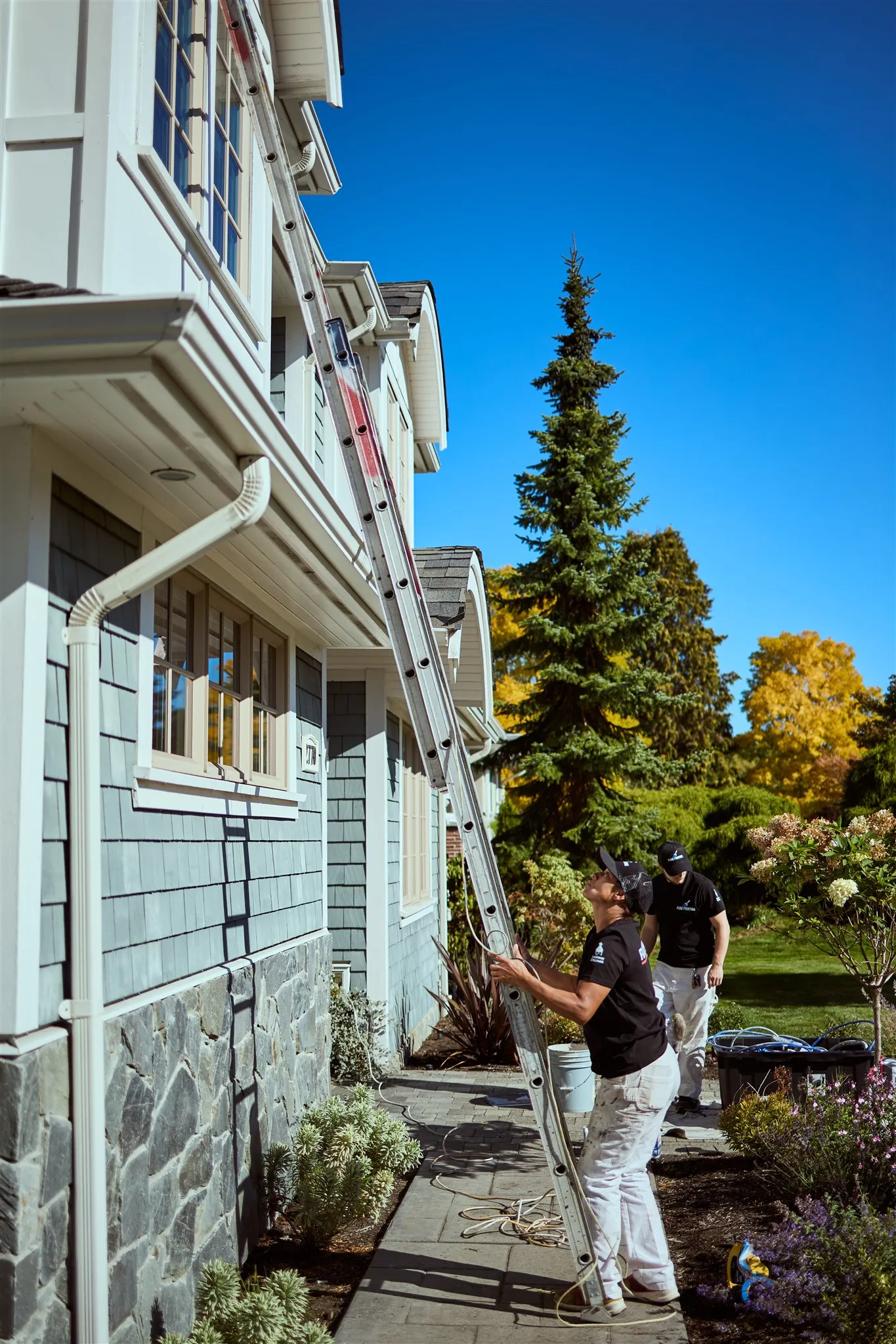 Flow Painting crew applying exterior paint to Victoria BC residential home