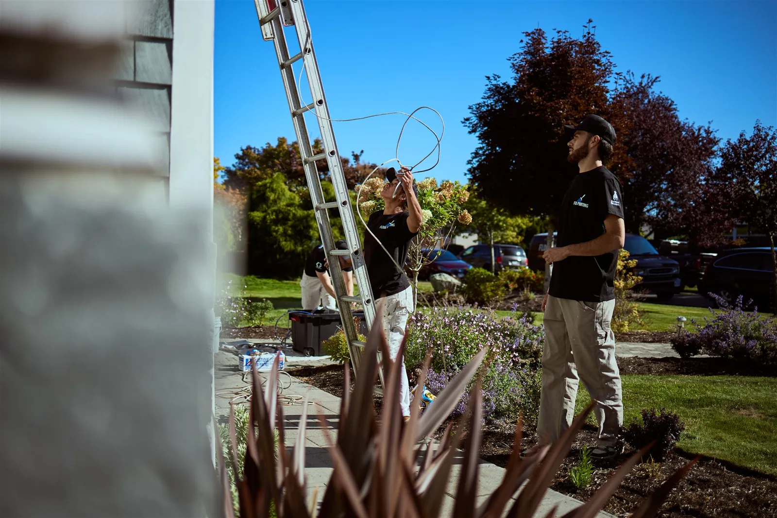 Professional painters working on house exterior painting project in Victoria