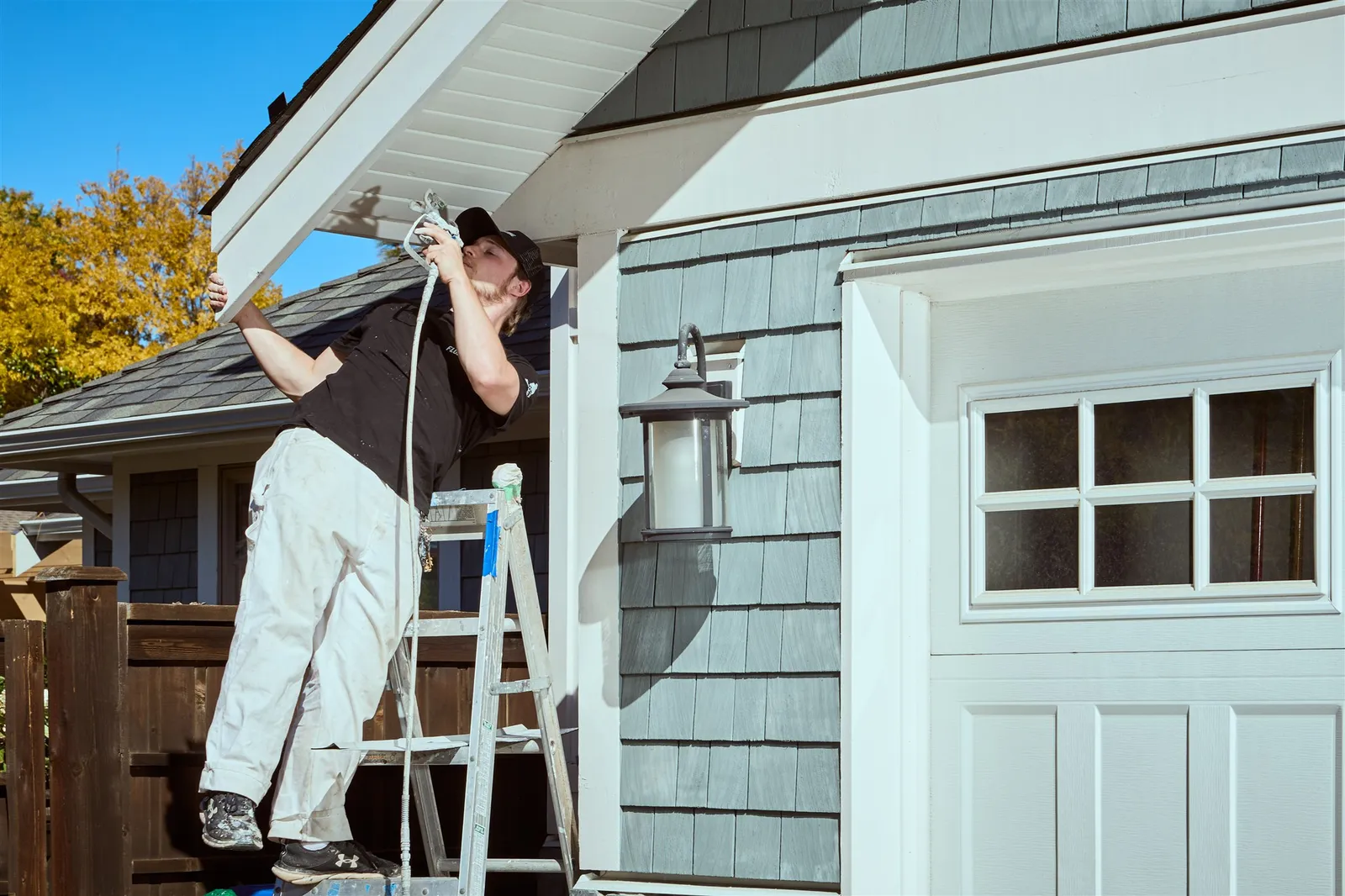 Professional painters working on house exterior painting project in Victoria
