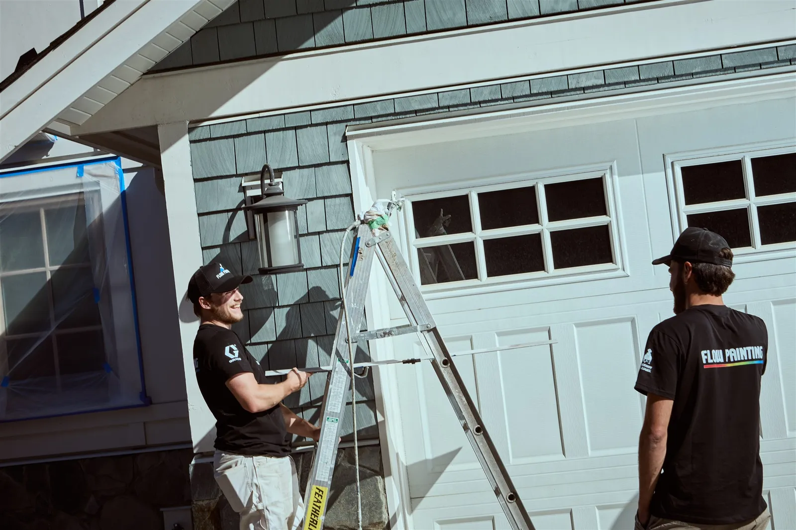 Flow Painting crew applying exterior paint to Victoria BC residential home