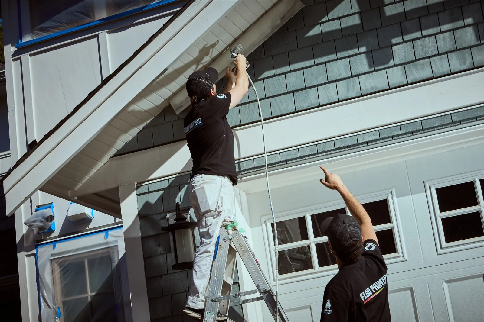 Professional painters working on house exterior painting project in Victoria