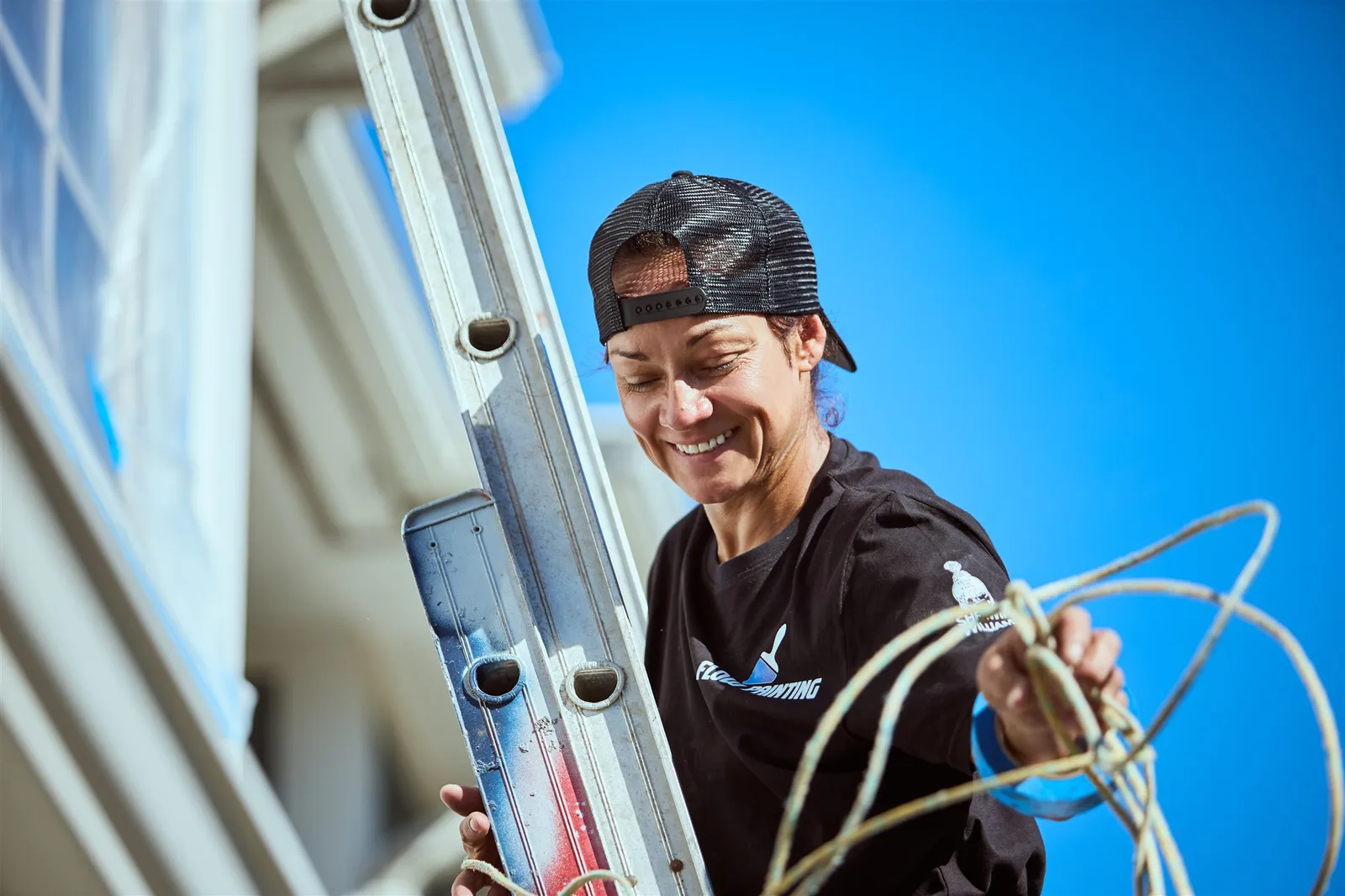 Professional painters working on house exterior painting project in Victoria