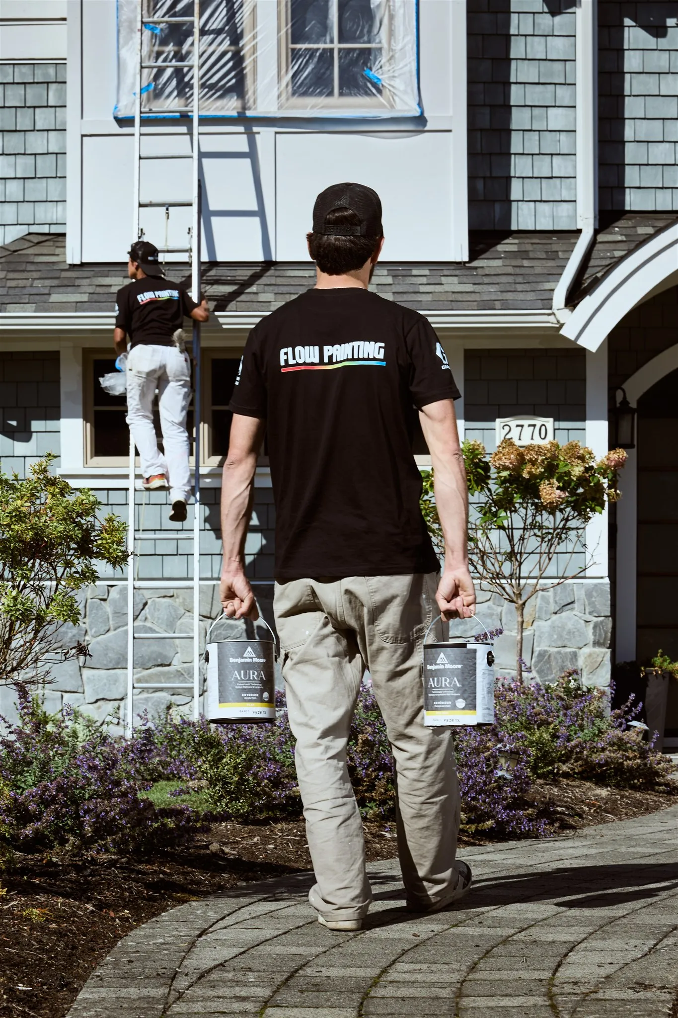 Professional painters working on house exterior painting project in Victoria