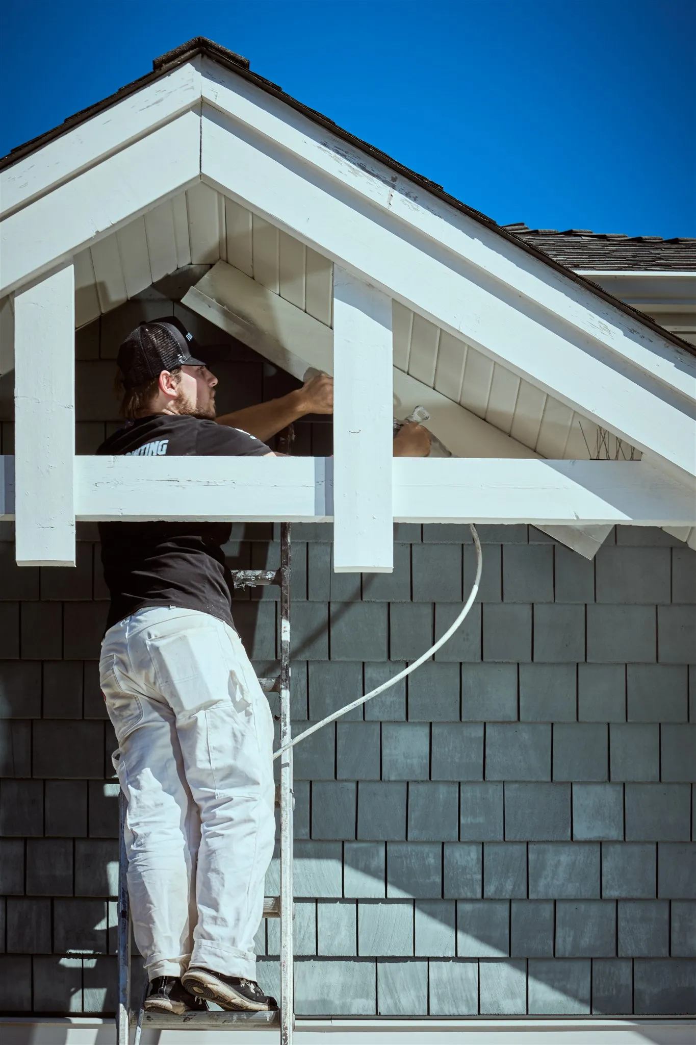 Professional painters working on house exterior painting project in Victoria