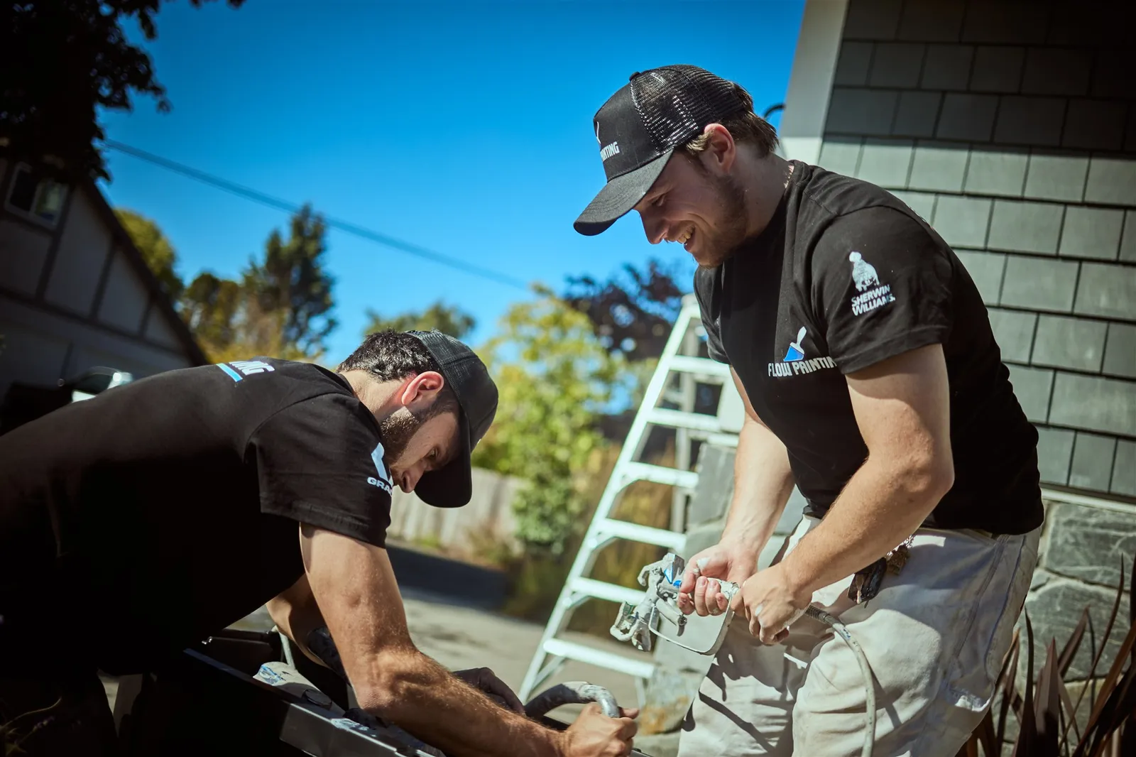 Professional painters working on house exterior painting project in Victoria