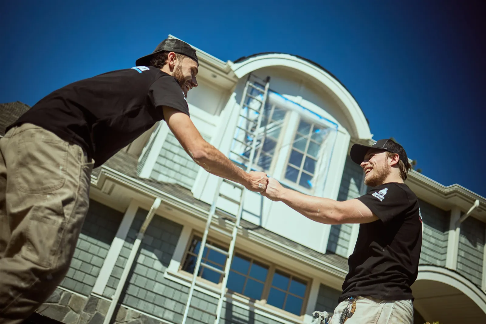 Professional painters working on house exterior painting project in Victoria