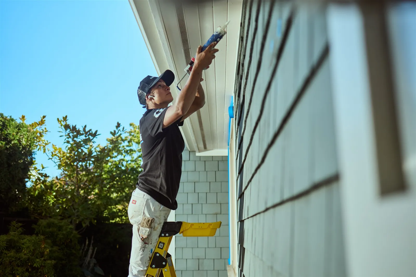 Professional painters working on house exterior painting project in Victoria