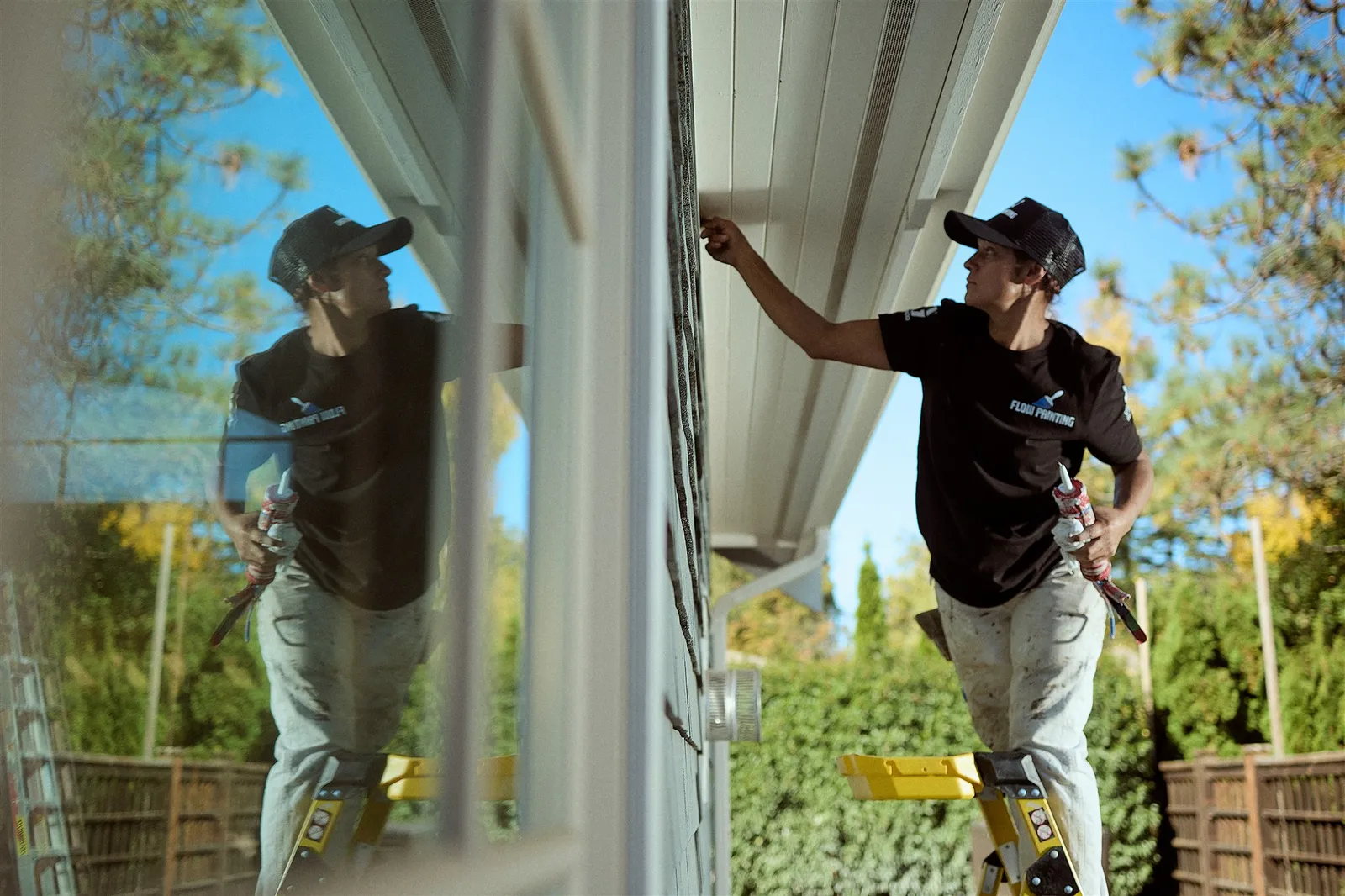 Professional painters working on house exterior painting project in Victoria