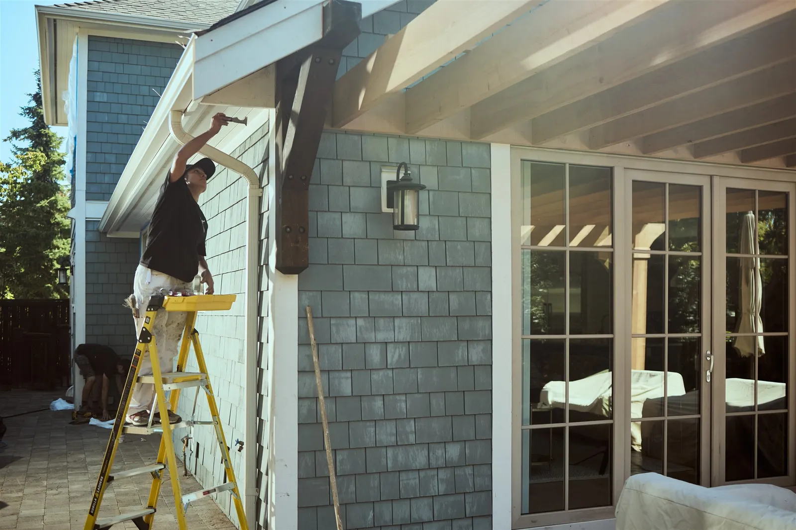 Professional painters working on house exterior painting project in Victoria