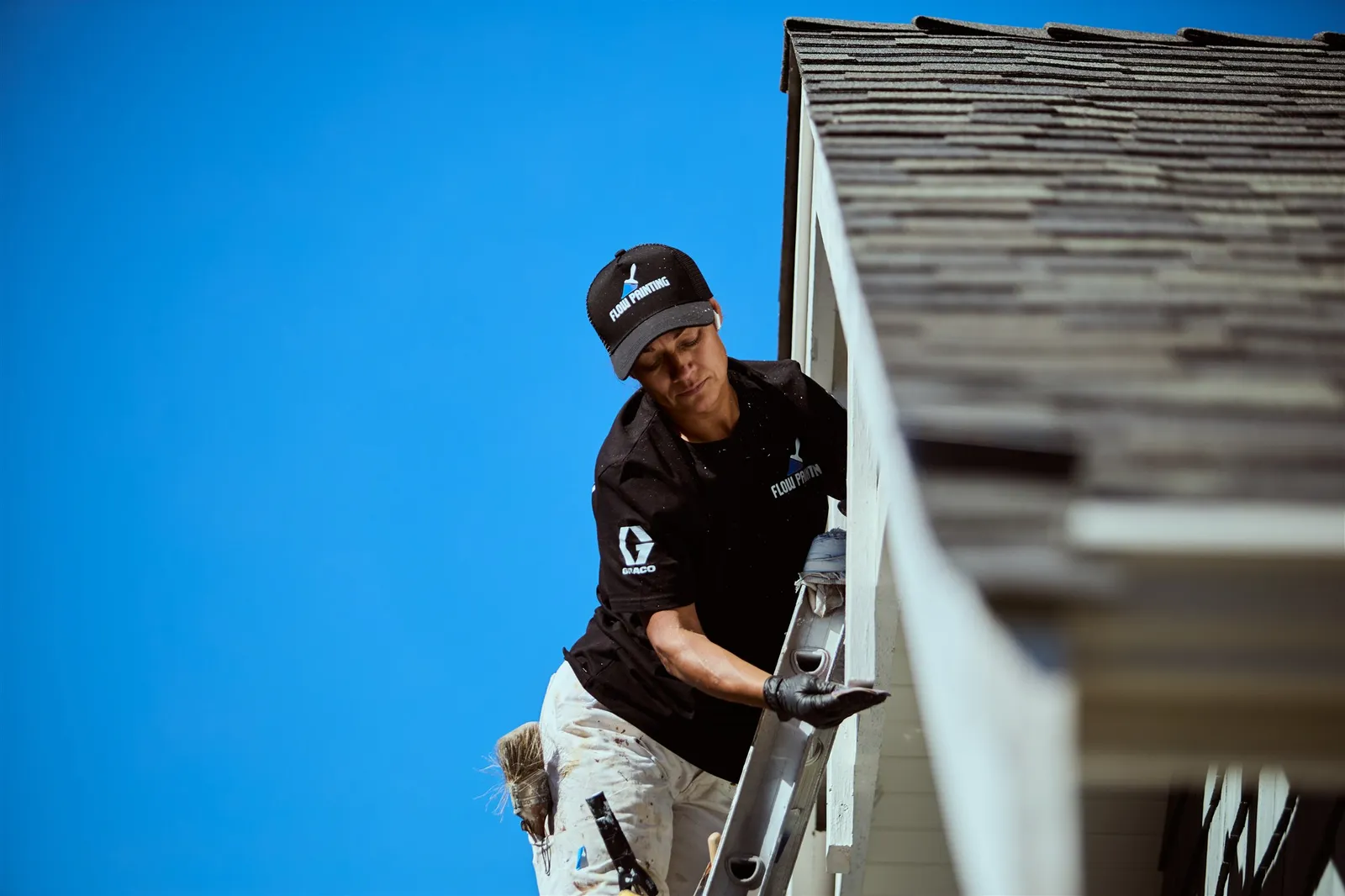 Professional painters working on house exterior painting project in Victoria