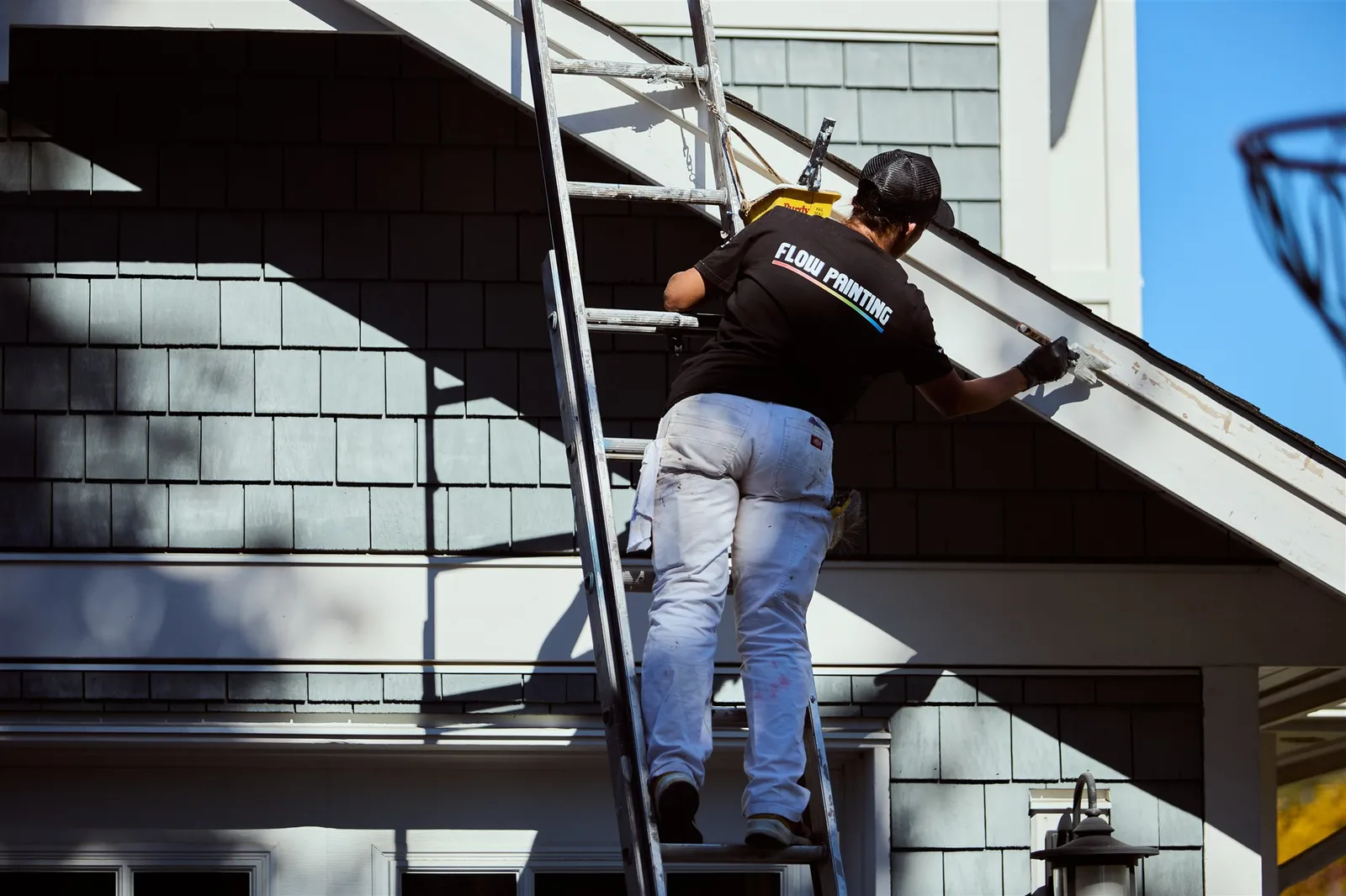 Professional painters working on house exterior painting project in Victoria